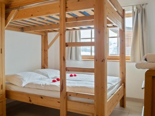 a wooden bunk bed in a room with a window at Maxima - Ski in - Ski Out in Flecken