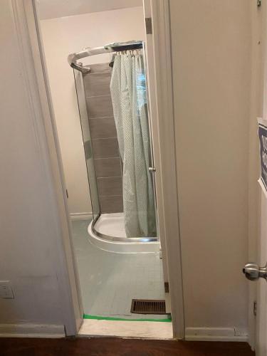 a shower in a bathroom with the door open at BUDGET Triple Room with En Suite Bathroom 36A in Toronto