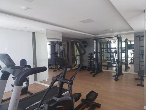 a gym with several tread machines in a room at Metrô Studio Alto do Ipiranga in Sao Paulo