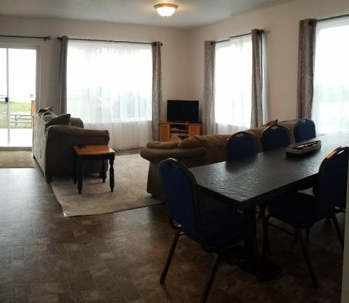 a living room with a table and a couch at The Lodge at Lyman's in Houghton Lake