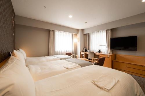 Tempat tidur dalam kamar di Richmond Hotel Sapporo Ekimae