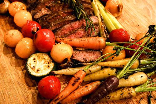 a bunch of vegetables on a wooden cutting board at Karuizawa Forest Seasons Villa in Karuizawa