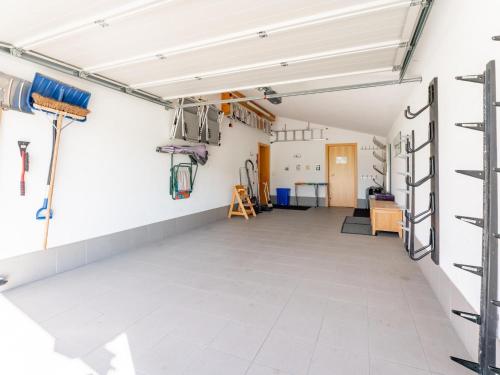 an empty room with white walls and white tile floors at Maxima - Ski in - Ski Out in Flecken