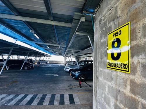 a parking lot with a number eight sign on a wall at El rincón de Tonella Apartamento completo muy equipado in Ibagué