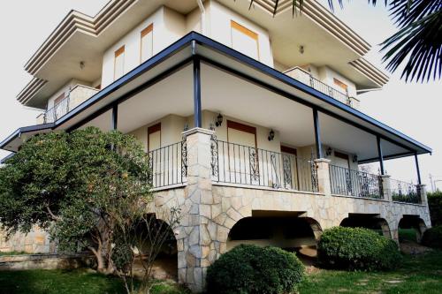 a large building with a balcony on top of it at Villa Bursa in Bursa