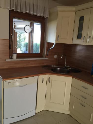a kitchen with white cabinets and a sink and a window at Villa Bursa in Bursa
