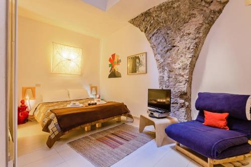 a bedroom with a king sized bed and a chair at Rome as you feel - Selci Apartment in Rome