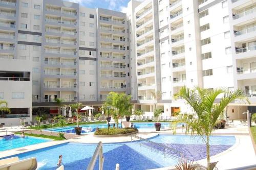 an image of a swimming pool in front of apartment buildings at Apartamentos em Rio Quente com maravilhosa área de lazer e excelente localização in Rio Quente