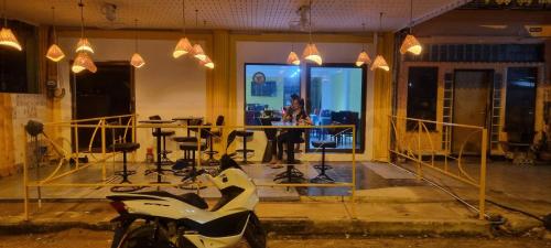 a motorcycle parked in front of a room with a table at Chez mamie in Pattaya South
