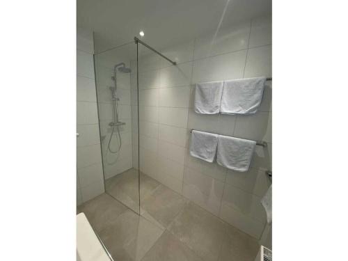 a glass shower stall with towels in a bathroom at Apartment Annemarie 4 in Meersburg