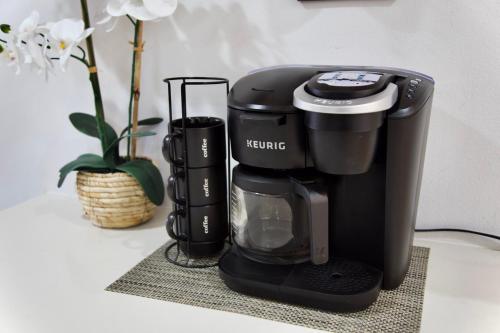 a coffee maker sitting on a table with a plant at Private Seattle Getaway Home Near Lake Washington! in Seattle