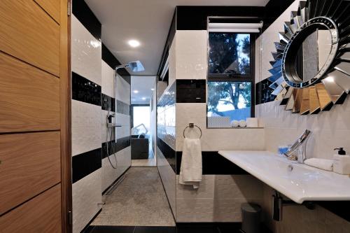 a bathroom with a sink and a mirror at Sea Star Rocks Boutique Hotel in Cape Town