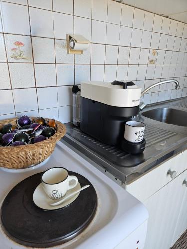 a cup of coffee sitting on a plate on a kitchen counter at MilosBluePearl in Triovasálos