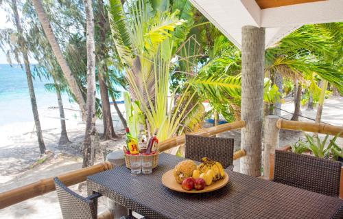 a plate of fruit sitting on a table on a balcony at Mabuhay Beach House in Boracay