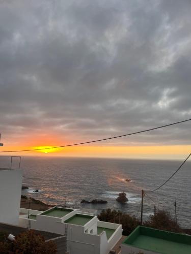 a view of the ocean at sunset from a house at Apartamento torres in Santa Cruz de Tenerife