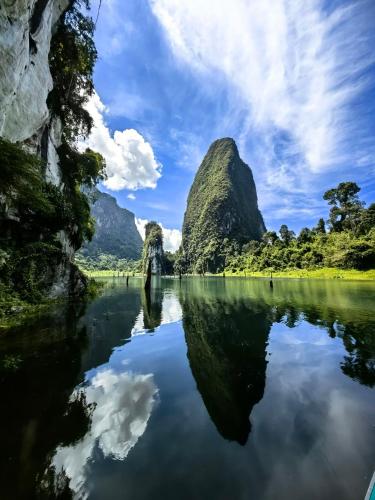 a view of a river with mountains in the background at Khao Sok Country Resort in Khao Sok
