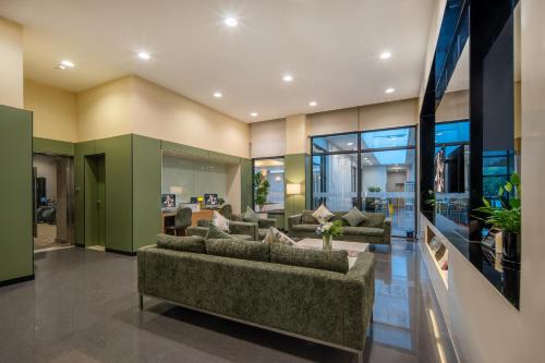 a large living room with couches and a table at Citadines Zhuankou Wuhan in Wuhan