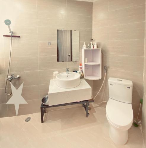 a bathroom with a white toilet and a sink at Châu Gia homestay in Thôn Văn Dương