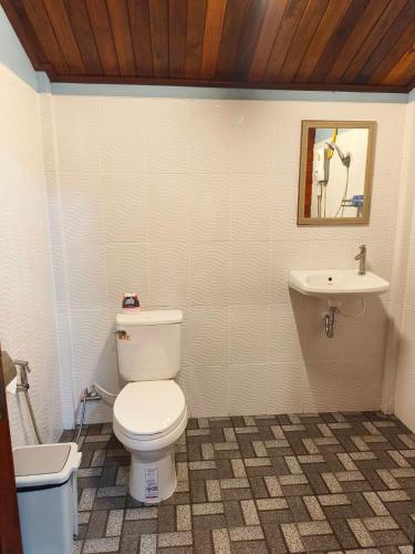 a bathroom with a toilet and a sink at Kohjum Seafront Resort in Ko Jum