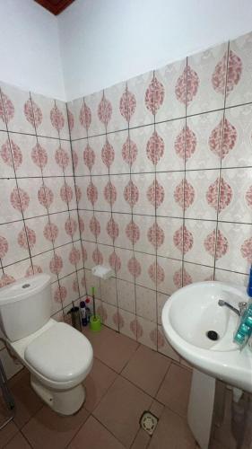 une salle de bain avec toilettes et lavabo dans l'établissement Sacha appartement 2 chambres, à Yaoundé