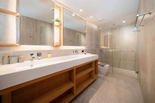 a bathroom with a large sink and a shower at Ocean Bliss - Sapphire Bay 3BR Apartment 812 with Terrace and Awe-Inspiring Views of Patong Bay in Patong Beach