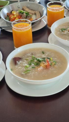 a table with a bowl of soup and plates of food at Charlee Khaoyai in Mu Si