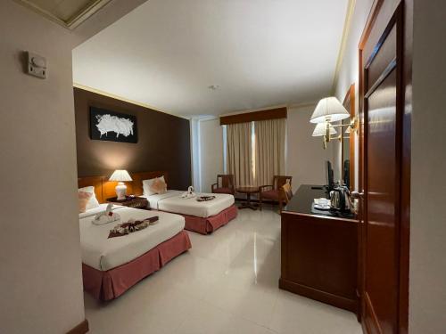 Ένα ή περισσότερα κρεβάτια σε δωμάτιο στο Songphanburi Hotel