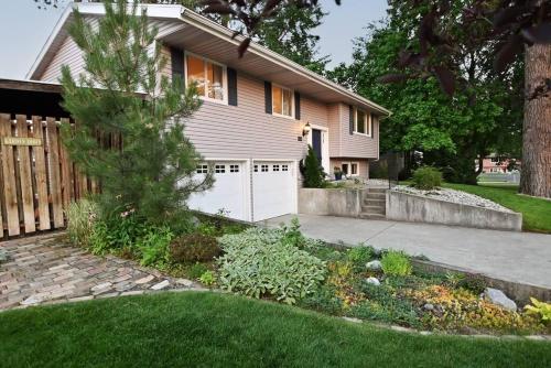 a house with a fence and a driveway at Windsor House in Spokane