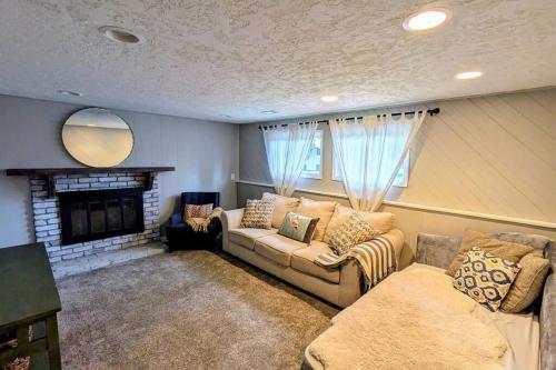 a living room with a couch and a fireplace at Windsor House in Spokane