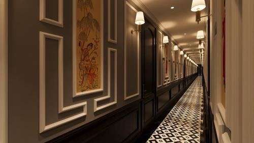 a hallway with a long corridor with lights on the walls at Majesty Luxury Prime Cruise by Premier Group in Ha Long