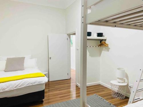 a bedroom with a bed and a loft bed at D109 Inner City Oasis on Buckingham in Melbourne