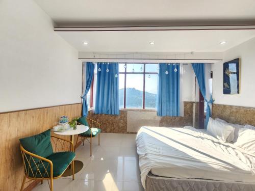 a bedroom with a bed and a table and a window at HOMESTAY NHÀ THỦy in Vung Tau