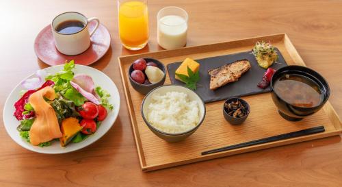 a table with a plate of food and a plate of rice at NOHGA HOTEL UENO TOKYO in Tokyo