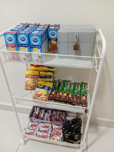 a shelf in a refrigerator filled with food and drinks at Hazz Homestay Alor Setar in Alor Setar