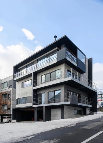 an apartment building with balconies on a street at Sekka Sekka in Kutchan