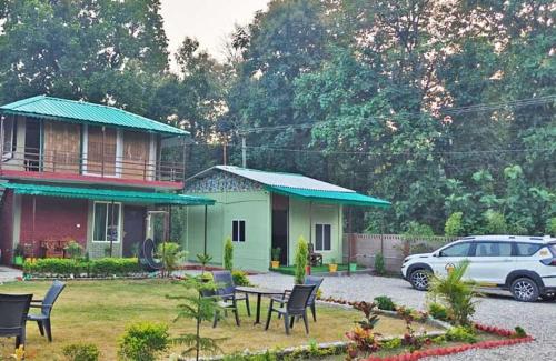 a house with a car parked in front of it at Corbett Sunrise India Homestay! in Rāmnagar