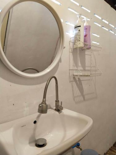 a bathroom with a sink and a mirror at Tiki Bar-KanTiang Guesthouse in Ko Lanta