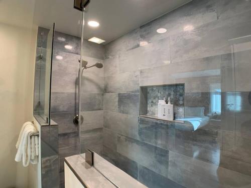 a bathroom with a shower and a sink at 4 Bedroom King Beds One-Story Tesla EV in Riverside