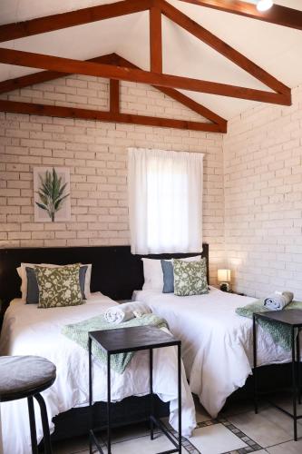 two beds sitting next to each other in a room at Rooiberg View Clarens in Clarens