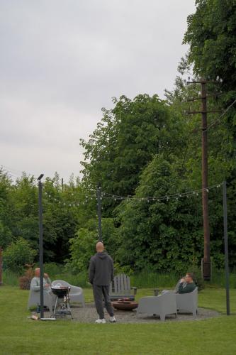 a man standing in a park with a grill at Harmonia Horyniec in Horyniec Zdrój