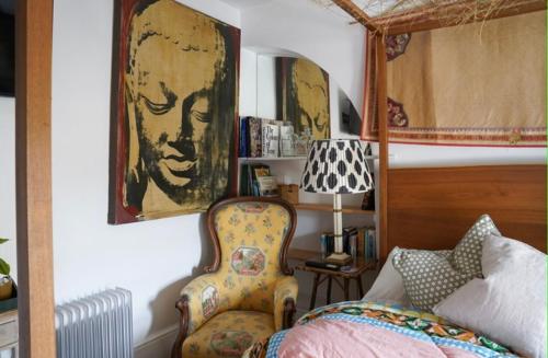 a bedroom with a bed and a chair and a picture at Stamford Lodge in Stamford