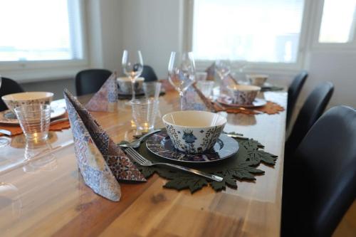 a dining room table with a bowl and a cup at 130m2 apartment with Sauna in Citycenter in Rovaniemi