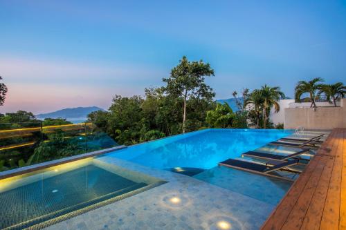 a pool with a view at a villa at Ocean Bliss - Sapphire Bay 3BR Apartment 812 with Terrace and Awe-Inspiring Views of Patong Bay in Patong Beach