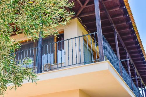 a balcony of a house with trees at Apartments Villa L&M Skiathos in Skiathos Town