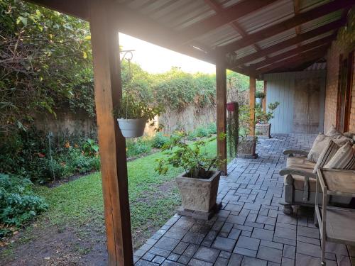 a patio with couches and potted plants on it at Serendipity in Kampersrus AH