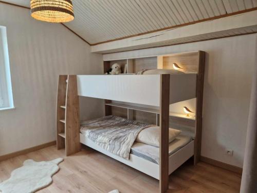 a bedroom with a bunk bed with a white bed at Chez Katy in Ban-sur-Meurthe-Clefcy