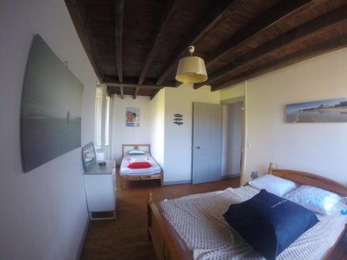 a bedroom with a bed and a room with two beds at Maison Picatzia - Pays Basque in Uhart-Mixe