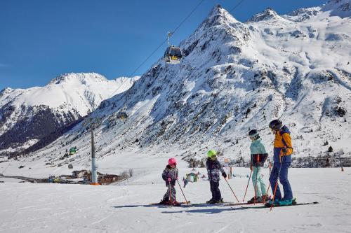 a group of people on skis on a snow covered mountain at Hotel Garni Bel-Ami in Galtür