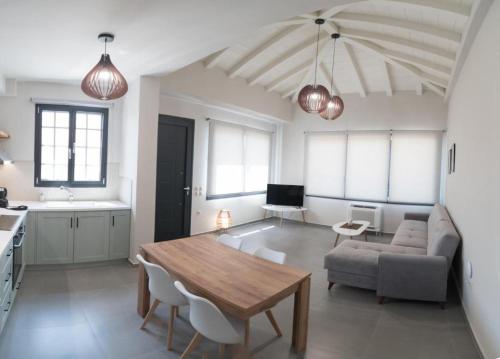 a living room with a table and a couch at Argolis Stone Homes in Kranidi