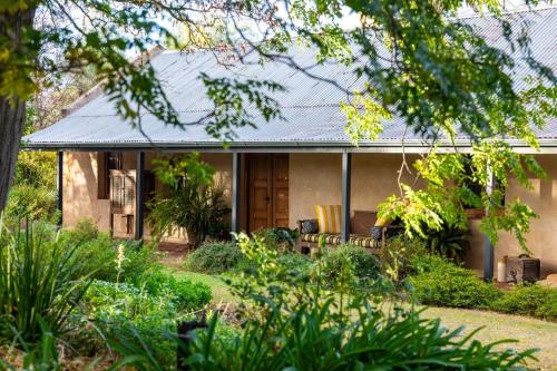 a house with a garden in front of it at Seppeltsfield Vineyard Cottage Luxury Romantic Getaway in Seppeltsfield